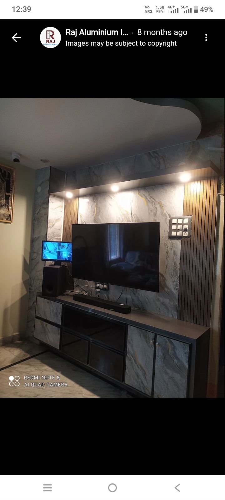 Modern marble-finish TV wall unit with dark cabinetry